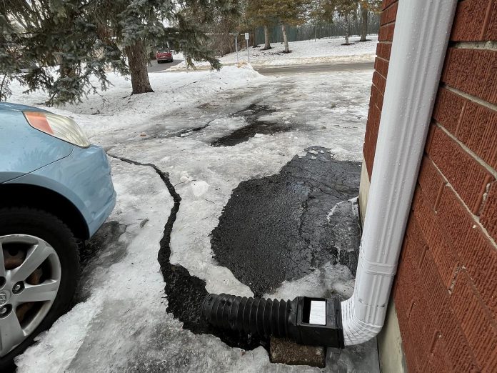 Keep downspouts from freezing in the winter by keeping gutters clean and free of snow and ice. Gutters and downspouts direct large amounts of rainfall from your roof away so that, in the spring, water does not pool in one area but instead is captured in nearby storm drains. (Photo: Leif Einarson)