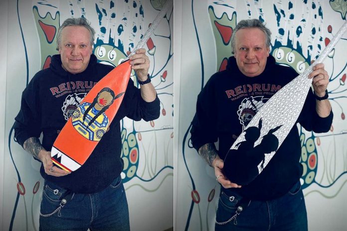 Peterborough DBIA executive director Terry Guiel displays both sides of the paddle he created for the third annual painted paddle outdoor art exhibit running in downtown Peterborough from March 3 to 24, 2023. Local artists and organizations have donated 31 painted paddles installed in storefront windows across downtown Peterborough that will be auctioned off to raise funds for a DBIA partnership with the One City Employment Program to establish a seasonal gardening team to employ people experiencing barriers to traditional employment. (Photos: Terry Guiel / Facebook)