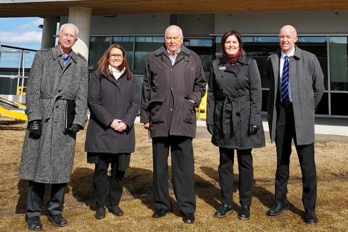  On March 30, 2023, the hospital unveiled new signage on the exterior northeast corner of the hospital proclaiming the 'James B. Neill Cardiac Centre' in recognition of James "Jim" Neill (middle), who  donated $5 million to the Peterborough Regional Health Centre (PRHC) Foundation in 2021 in support of cardiac care at the hospital. Also pictured from left to right are PRHC president and CEO Dr. Peter McLaughlin, PRHC cardiac cath lab patient and registered nurse Jennifer Scriver, PRHC Foundation president and CEO Lesley Heighway, and PRHC cardiologist and head of cardiology Dr. Warren Ball.  (Photo courtesy of PRHC Foundation)