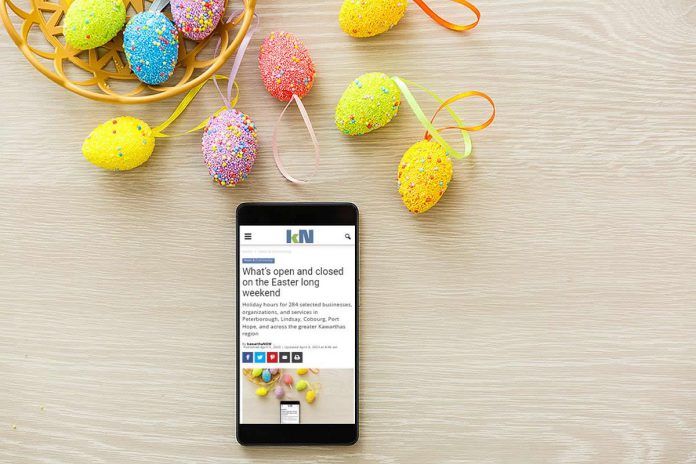 A mobile phone sitting on a table by a basket of Easter eggs showing the kawarthaNOW website. (Photo: kawarthaNOW0