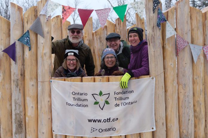 GreenUP executive director Tegan Moss (right) with donors and supporters Kim Zippel and Sue Sauve (front) and Ian Attridge and Mark Zippel (back) in the naturalized playscape's puppet theatre at Ecology Park during an opening celebration on March 31, 2023. The natural playscape was also funded by a $52,800  Ontario Trillium Foundation grant.  (Photo: Lili Paradi / GreenUP)