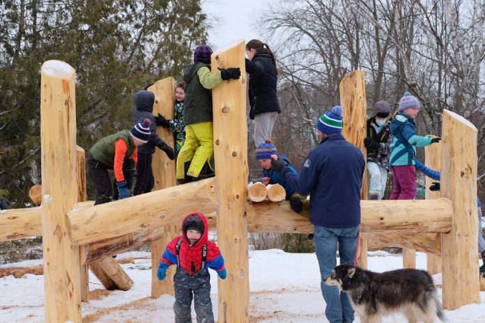 The Keresztesi family plays on the new naturalized playscape at Ecology Park during a celebration hosted by GreenUP on March 31, 2023. (Photo: Lili Paradi / GreenUP)