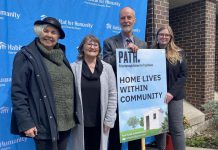 Peterborough Action for Tiny Homes (PATH) chair Trish Campbell, Habitat for Humanity Peterborough and Kawartha Region CEO Susan Zambonin, Peterborough Action for Tiny Homes land acquisition working group lead Keith Dalton, and Habitat for Humanity communications and donor services manager Jenn MacDonald gathered outside Habitat for Humanity's Milroy Drive location on April 25, 2023 to announce details of a new partnership destined to provide interim solutions to the local homelessness crisis. (Photo: Paul Rellinger / kawarthaNOW)