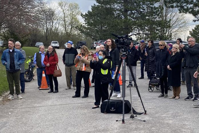 A crowd featuring, among others, Peterborough city councillors Alex Bierk and Joy Lachica (far left), gathered outside Habitat for Humanity's Milroy Drive location on April 25, 2023 to hear details of a partnership between Habitat for Humanity and Peterborough Action for Tiny Homes (PATH) destined to provide interim solutions to the local homelessness crisis. (Photo: Paul Rellinger / kawarthaNOW)