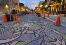 Nuin-Tara Morin and assistant Chris Boyd complete the "Nothing Out of Reach" road mural in July 2022 as part of the City of Peterborough's 2022 Renaissance on Hunter public art project. Nuin-Tara Morin is one of the four artists in the 2022 program who will serve as mentors for 10 local artists to be selected for the 2023 Road Mural Mentorship Program. (Photo: City of Peterborough Public Art Program / Facebook)