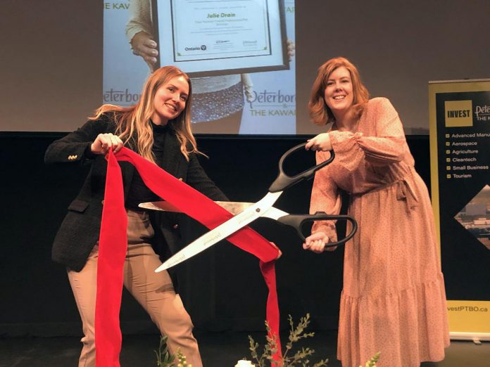 Madeleine Hurrell (right), Manager of Peterborough & the Kawarthas Economic Development's Business Advisory Centre, and Ella Fischer-Slack (left), Business Advisory Centre Coordinator, cut the ribbon at a recent event that showcased 24 entrepreneuers who participated in the Starter Company Plus program during the pandemic. Applications for the spring 2023 intake of the entrepreneurial training program close on April 30. (Photo courtesy of Peterborough & the Kawarthas Economic Development)