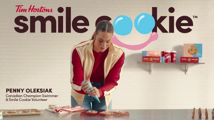 Champion Canadian swimmer Penny Oleksiak is the spokesperson for the annual Tim Hortons Smile Cookie campaign, taking place this spring for the first time. Oleksiak is a long-time advocate of Smile Cookie who volunteered to decorate cookies at her local Tim Hortons when she was younger. (Photo: Tim Hortons)