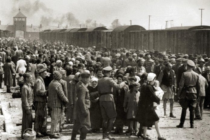 Hungarian Jews being "selected" for either forced labour or the gas chamber on the ramp at Auschwitz II-Birkenau in German-occupied Poland around May 1944. The photograph is part of the collection known as the Auschwitz Album, the only surviving visual evidence of the process leading to mass murder at Auschwitz-Birkenau. The album was donated to Yad Vashem by Lili Jacob, a survivor who found it in the Mittelbau-Dora concentration camp in 1945. (Anonymous photographer / public domain)