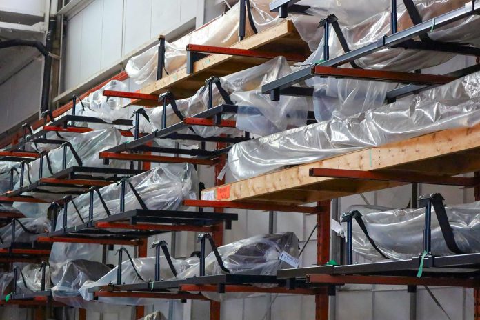 Canoes, encapsulated and in cradles, line the walls of the Collection Centre at The Canadian Canoe Museum's Monaghan Road location, in preparation for the museum's move to its new home currently under construction at the water's edge on Little Lake in the heart of Peterborough. (Photo courtesy of The Canadian Canoe Museum)