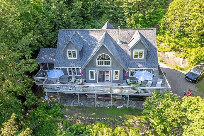 Welcome to Reverence on Kennisis Lake, a gorgeous Canadian Shield cottage with granite outcrops located in the heart of the 100,000-acre Haliburton Forest. This log-construction cottage will serve as your base for all the outdoor adventure the region has to offer. (Photo courtesy of Cottage Vacations)