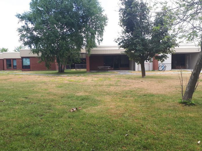 While the backyard space at Five Counties Children's Centre's Peterborough location has always been used for recreation therapy and other programs, it originally hosted playground equipment for a daycare and classroom until the daycare was closed and the equipment removed. With the support of individual donors, local service clubs, businesses, and  Peterborough GreenUP, the backyard space began its transformation three years ago from a fairly standard and non-descript landscape (pictured) into a lush, natural outdoor treatment and therapy space. (Photo courtesy of Five Counties Children's Centre)