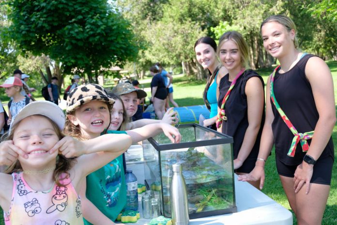 During the first day of the annual Peterborough Children's Water Festival on May 30, 2023, elementary school students participated in the Sponge Bog Frog activity centre (led by students from St. Peter Catholic Secondary School) to teach students how pollutants in water can harm frogs. (Photo: Lili Paradi / GreenUP)