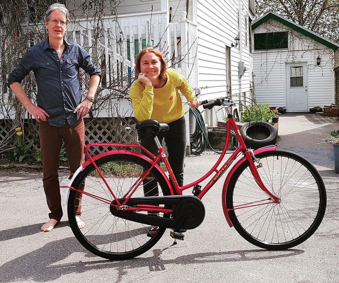 Three Sisters Natural Landscapes cofounder Carlotta James with her bike and her husband Tim Haines. Three Sisters uses bike power to arrive at consultations and for fall clean-up services, thereby lowering the emissions of the business. (Photo: Three Sisters Landscaping)
