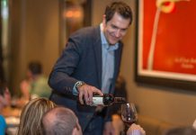Louis Karkabasis, owner and sommelier of Pane Vino Trattoria & Wine Bar in Lindsay, serves a customer at the popular Italian restaurant, which will be closing after May 27, 2023. (Photo via Pane Vito website)