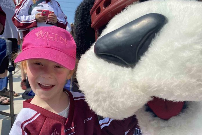A thrilled four-year-old Audrey got up close and personal with Peterborough Petes' mascot Roger during a community celebration of the club's Ontario Hockey League championship held Monday (May 22) at Quaker Foods City Square in downtown Peterborough. Audrey made the trip from Omemee with her mom.  (Photo: Paul Rellinger / kawarthaNOW)