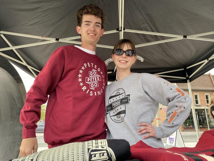 Looking good in their Peterborough Petes apparel during the community watch party held held on May 19, 2023 at Quaker Foods City Square were Taigen Overvelde and Tanya Harwood. The duo waa kept busy working the PTBO Northern Originals/Flavour booth, selling Petes clothing and hats. (Photo: Paul Rellinger / kawarthaNOW)