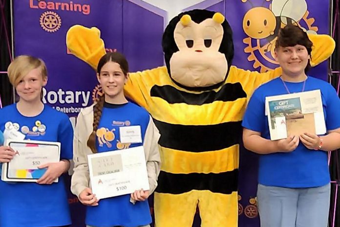 Buzz the Spelling Bee mascot with the top three spellers in the senior division (grades 7 and 8) at the Rotary Club of Peterborough's ninth annual School Spelling Bee held on May 13, 2023. From left to right: Crepe Cochrane (third), Sonny Gillis (second), and Noah Hofman (first). (Photo courtesy of Rotary Club of Peterborough)