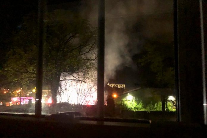 A Peterborough resident living on the south side of Dalhousie Street took this photo from an uptairs window of a late-night fire at at the Wolfe Street encampment in downtown Peterborough on May 18, 2023. (Photo supplied to kawarthaNOW)
