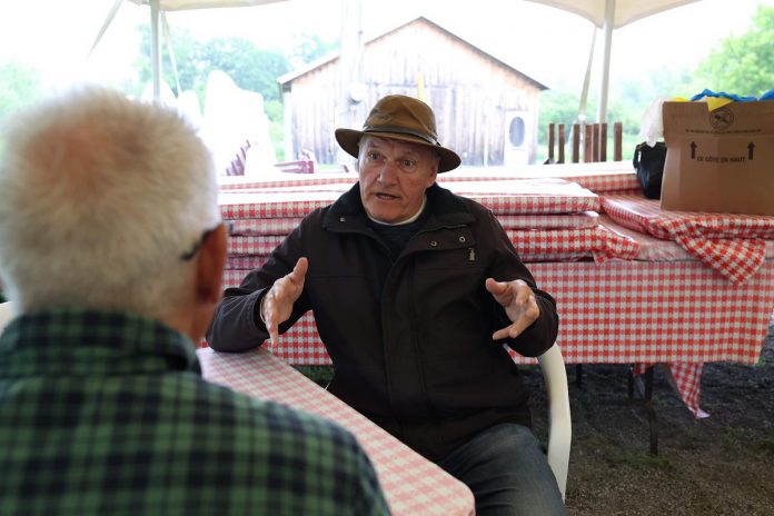 "The Tilco Strike" playwright D'Arcy Jenish speaks with kawarthaNOW writer Paul Rellinger during 4th Line Theatre's media day on June 14, 2023. The play runs Tuesdays to Saturdays from June 27 to July 22 at the Winslow Farm in Millbrook. (Photo: Heather Doughty / kawarthaNOW)