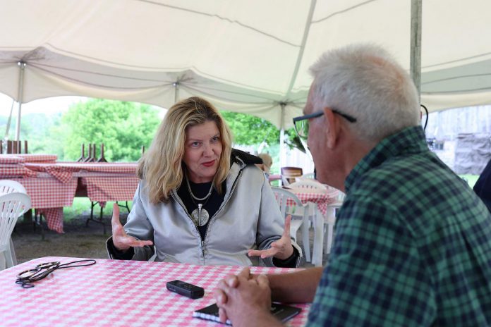 "The Tilco Strike" director Cynthia Ashperger speaks with kawarthaNOW writer Paul Rellinger during 4th Line Theatre's media day on June 14, 2023. The play runs Tuesdays to Saturdays from June 27 to July 22 at the Winslow Farm in Millbrook. (Photo: Heather Doughty / kawarthaNOW)