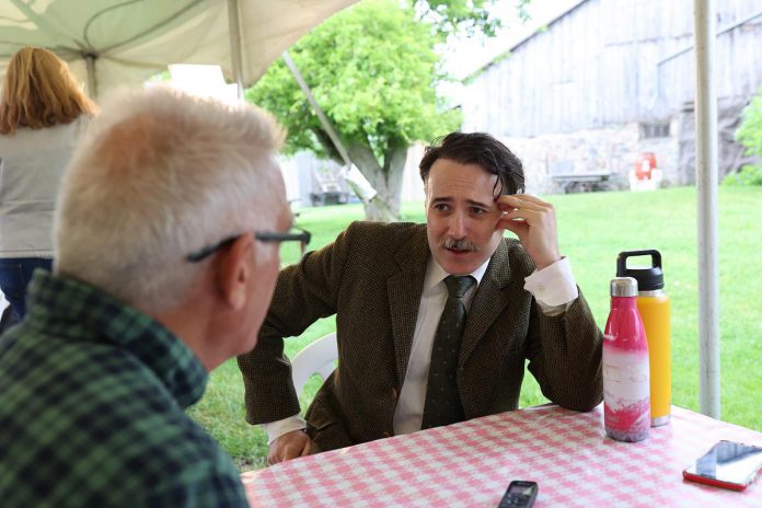Actor M. John Kennedy, who portrays Tilco Plastics co-owner Harold 'Dutch' Pammett in "The Tilco Strike", speaks with kawarthaNOW writer Paul Rellinger during 4th Line Theatre's media day on June 14, 2023. The play runs Tuesdays to Saturdays from June 27 to July 22 at the Winslow Farm in Millbrook. (Photo: Heather Doughty / kawarthaNOW)