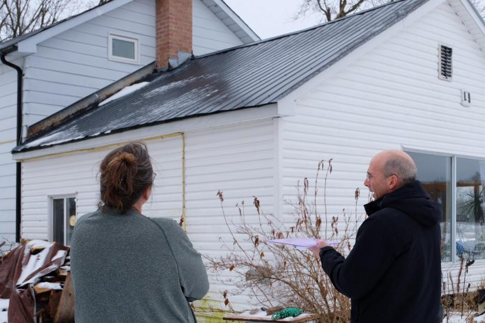 GreenUP's registered energy advisor Bryn Magee assesses a home in Douro this past winter. GreenUP is one of the providers of pre-retrofit home energy assessments in the K9H, K9J, K9K, K9L, K0L, L0A, K9V, K0M-Trent Lakes, L1A, and K9A postal codes. (Photo: Lili Paradi / GreenUP)