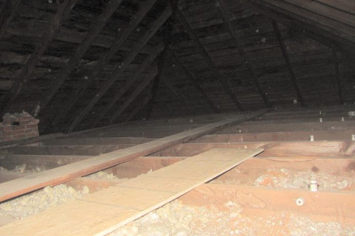 This attic contains only about three or four inches of insulation, for an R-value of less than 12. Today's building code requires a minimum of R50 in attics, or at least 14 inches of blown-in cellulose or 18 inches of blown-in fiberglass. In this attic, insulating to R50 resulted in 11 per cent energy savings. (Photo: Clara Blakelock / GreenUP)