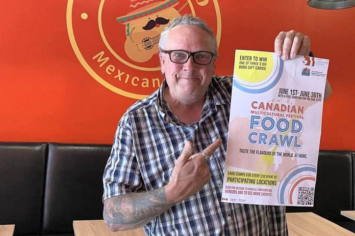 Terry Guiel, executive director of the Peterborough Downtown Business Improvement Area (DBIA), with a poster for the New Canadians Centre's 2023 Multicultural Food Crawl at Poco Burro, one of 10 downtown restaurants participating in the food crawl that runs during the month of June, with a free sampling day on June 24 and the chance to win Boro gift cards. (Photo courtesy of Terry Guiel)