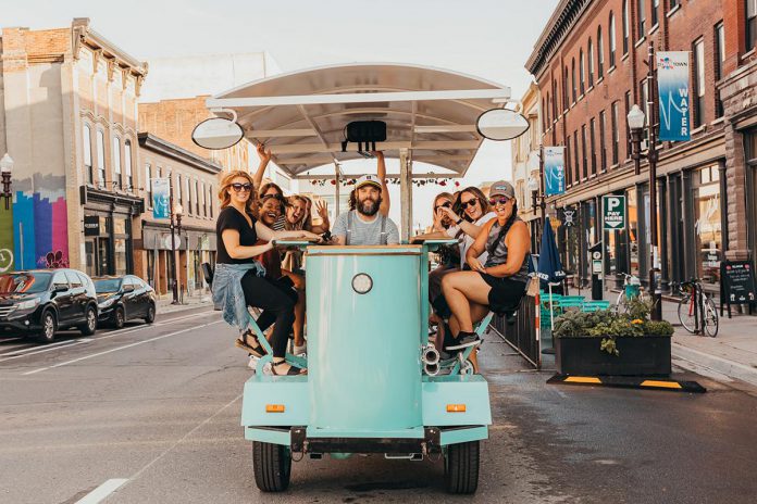 "Captain Pete" Rellinger steers PedalBoro's 15-passenger party bike on Water Street in downtown Peterborough. PedalBoro is available for pub crawl tours and private parties as well as unique team-building experiences Fridays through Sundays from June until October. (Photo: Photography with Care)