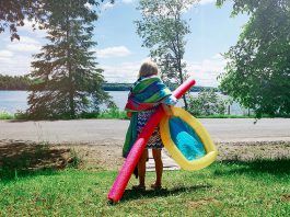 A young girl with gear during summer heading to a beach for a swim. (Stock photo)