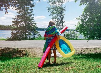 A young girl with gear during summer heading to a beach for a swim. (Stock photo)