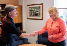 The Theatre On King's artistic director Ryan Kerr shakes hands with property manager Kristi Dick at Cherney Properties after renewing the black-box theatre's lease for another two years. In support of The Theatre On King, Cherney Properties owner Michael Cherney renewed the lease at 2018 rental rates. (Photo courtesy of The Theatre On King)