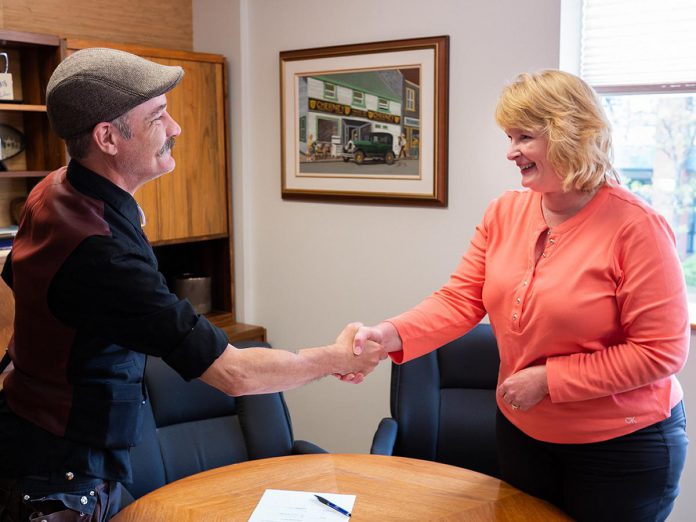 The Theatre On King's artistic director Ryan Kerr shakes hands with property manager Kristi Dick at Cherney Properties after renewing the black-box theatre's lease for another two years. In support of The Theatre On King, Cherney Properties owner Michael Cherney renewed the lease at 2018 rental rates. (Photo courtesy of The Theatre On King)