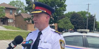 Peterborough police chief Stuart Betts addresses the media in the parking lot across from the Wolfe Street overflow shelter for people who are homeless. A woman in the Wolfe Street tent encampment was shot and later died in hospital in the early morning hours of June 2, 2023. (Photo: Paul Rellinger / kawarthaNOW)