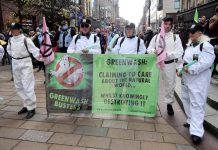 A greenwash march in Glasgow Bristol in the U.K. in November 2021. The term 'greenwashing' was coined in the 1980s in an essay by environmentalist Jay Westerveld, who criticized the hotel industry's "save your towel" movement that was marketed as a way for guests to help hotels conserve water while it was actually a way for hotels to reduce laundry labour expenses and made a minimal difference in water usage. (Photo: Bristol Airport Greenwashbusters via Wikipedia)