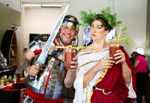 Terry Guiel, executive director of the Peterborough Downtown Business Improvement Area (DBIA), with local performance artist Naomi Duvall launching Peterborough's first-ever Caesar Fest. From July 13 to 31, 2023, 11 downtown restaurants, pubs, and cafes are featuring their own unique and savoury cocktails, mocktails, and food dishes in homage to Canada's favourite cocktail, vying to be crowned Caesar Fest victor through online votes. Duvall will be "Rome-ing" around downtown as Julia Caes-her during Caesar Fest to promote the event. (Photo courtesy of Peterborough DBIA)
