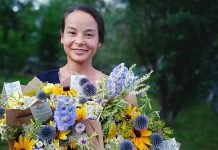 Summer Roads Flower Company owner Beatrice (Bea) Chan with some of the bouquets she sells from the seasonal flowers she grows on Summer Roads Farm between Lakefield and Young's Point. The business arose from a restoration project that Bea began five years ago on her parents' property, when she transformed compact driveway fill into a regenerative pasture. (Photo courtesy of Bea Chan)