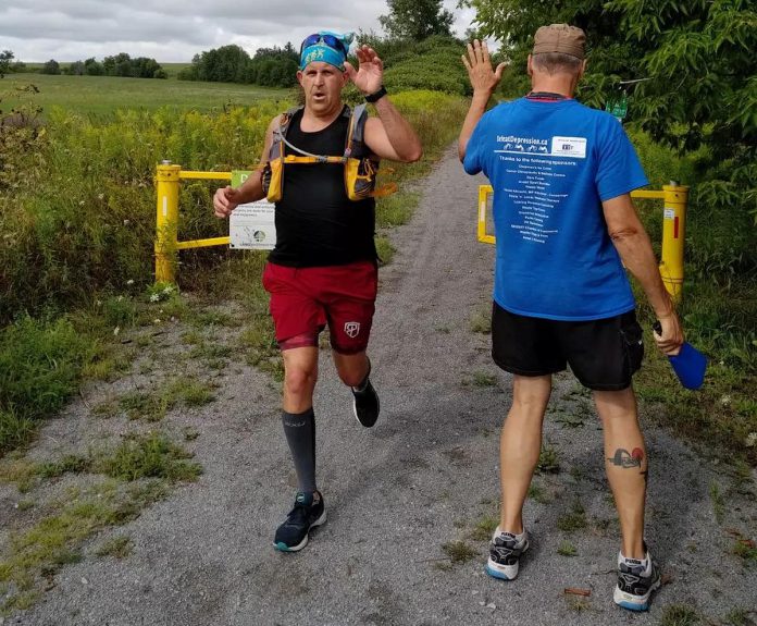 Peterborough runner Joel Kimmett gets a high five from Clay Williams during the 2022 Canal Pursuit For Mental Health. Joel and his wife Eileen will both participate in the 2023 event, running 10 kilometres each from Brechin south of Orillia to Lock 34 in Fenelon Falls on August 20, 2023. (Photo: Canal Pursuit For Mental Health)