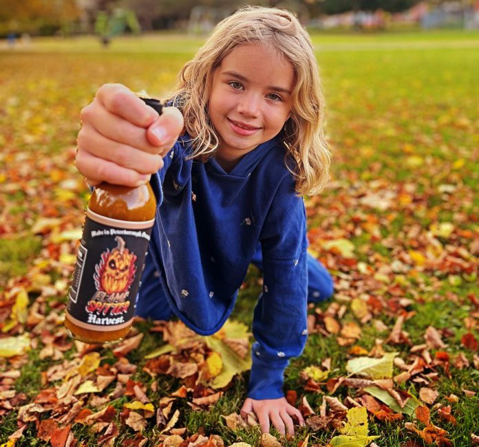 With support from his family, including his wife (who now owns a piece of the business) and their young daughter, Flame Spitter Hot Sauce owner Mitchell Lowes has committed to his sobriety, which he links to the growing success of his business. (Photo courtesy of Flame Spitter Hot Sauce)