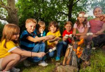 A group of children roasting marshmallows over a campfire. (Stock photo)