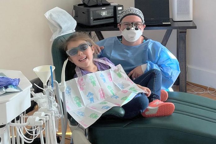 Registered dental hygienist Kara Parcells with a young client at Evolve Dental Hygiene in Lindsay. Many people are unaware they can get dental hygiene care outside of a traditional dental office. (Photo courtesy of Evolve Dental Hygiene)