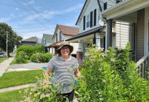 Peterborough resident Cass Stabler in her front yard rain garden surrounded by wild bergamot, a native plant that flowers from mid to late summer and is adored by many native pollinators. Stabler applied for and received a rain garden subsidy from the City of Peterborough in 2020, the first year the program was offered. (Photo: Hayley Goodchild / GreenUP)