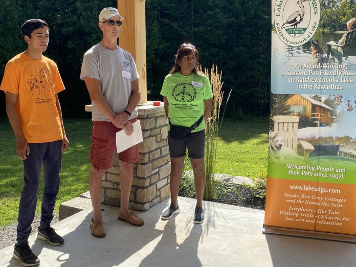 Steve and Anne Wildfong, with their son Jakob, are the owners of Lake Edge Cottages, a 12.5-acre resort property near Young's Point. With the help of financial assistance from the federal government, they chose to update to solar energy to decrease energy costs while benefiting the environment. An official ribbon-cutting ceremony for the installation of 110 solar panels at the resort was held on August 16, 2023. (Photo: Paul Rellinger / kawarthaNOW)