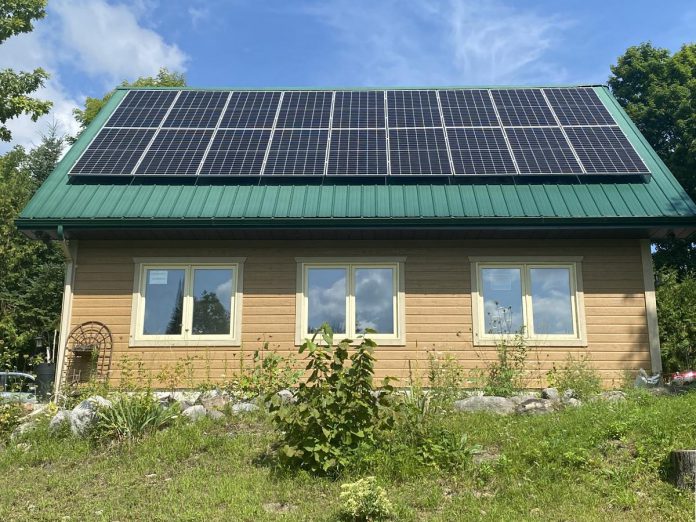 The 110 solar panels installed on the roofs of three structures at Lake Edge Cottages, a 12.5-acre resort property near Young's Point, produce twice as much energy as the resort uses on sunny days. The excess energy goes back into the Hydro One grid where it can be used by other households and businesses.  (Photo: Paul Rellinger / kawarthaNOW)