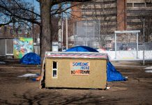 A photo of a shelter in Toronto's Alexandra Park from an April 16, 2021 New York Times story by Catherine Porter about carpenter Khaleel Seivwright, who built small life-saving shelters for unhoused people living outside in Toronto during the first winter of the pandemic. Seivwright's story is told in Zac Russell's award-winning documentary "Someone Lives Here", which is screening on September 8, 2023 at Artspace in Peterborough as part of ReFrame Film Festival's free Mission Miniseries presented by the Peterborough Downtown Business Improvement Area. (Photo: Ian Willms for The New York Times)
