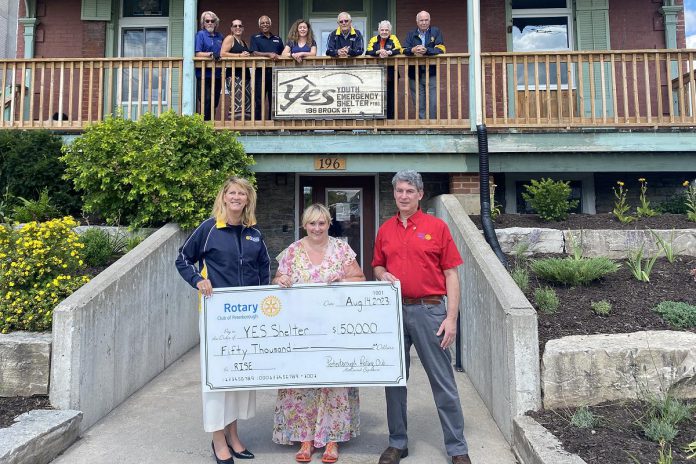 Rotary Club of Peterborough president Betty Halman-Plumley (front left) and Rotary Club of Peterborough Kawartha president Paul Landau (front right) presented a $50,000 cheque to YES Shelter for Youth and Families executive director Aimee Le Lagadéc on August 14, 2023. Pictured in the background are Rotarians Lloyd Graham, Laurie Heigh, Atul Swarup, Morris Cox, Paula Wager, and Mike Evans. (Photo courtesy of Rotary Club of Peterborough)