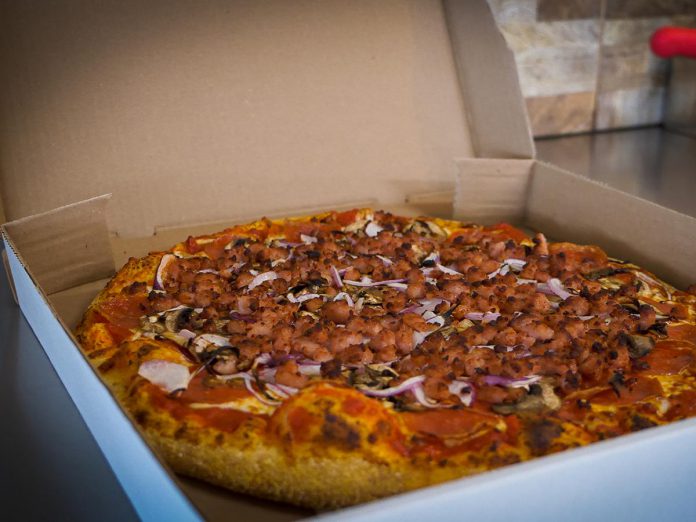 For Kawarthas Northumberland's Taste of the Trent-Severn Waterway culinary program, Pizza Alloro in Buckhorn is slicing up the Trail Town Special Pizza, which is a take on the traditional Canadian pizza, made with  mushroom, pepperonis, bacon, and onions. (Photo courtesy of Kawarthas Northumberland / RTO8)
