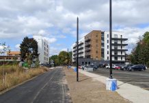 Looking north along the Rotary Greenway Trail in Peterborough's East City to two of the buildings in Ashburnham Realty's residential-commercial development. The city's committee of adjustment approved an increase of a third residential building to be constructed along the trail to the south from three to six storeys, drawing the ire of some neighbouring residents. Developer Paul Bennett says the height of the third building is doubling as a fourth building is no longer going ahead, and the total number of units in the development remains the same. (Photo: Bruce Head / kawarthaNOW)