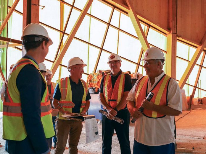 Canadian Canoe Museum curator Jeremy Ward (third from right) shares a laugh with Peterborough-Kawartha MPP Dave Smith (second from right) and Ontario Minister of Tourism, Culture and Sport Neil Lumsden (right) during a tour at the end of July of the new Canadian Canoe Museum under construction at 2077 Ashburnham Drive in Peterborough. (Photo courtesy of The Canadian Canoe Museum)