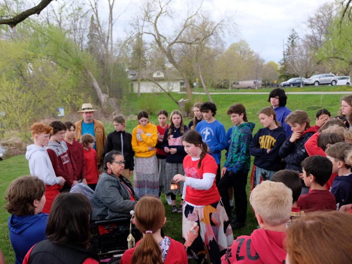 Curve Lake First Nation Elder Dorothy Taylor speaks to the importance of understanding the history of damage done to nibi, or water, using teachings from Indigenous knowledge systems to a group of students from Immaculate Conception Catholic Elementary School at a Water Walk at Little Lake in Peterborough earlier this year. (Photo: Lili Paradi / GreenUP)